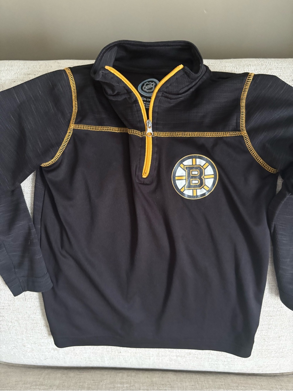 NHL Black Pullover with Gold Zipper Trim